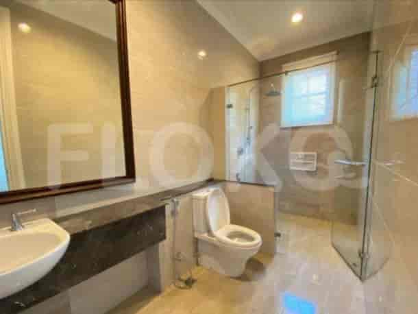 A modern bathroom featuring a glass-enclosed shower and a vanity unit with a large mirror.