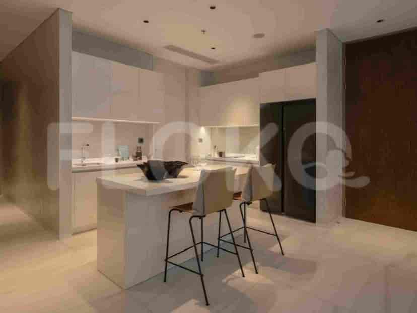 A modern open-plan kitchen with a central island and bar stools.