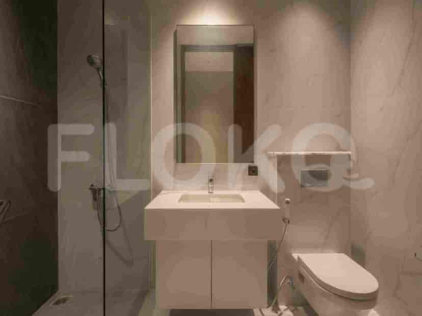 A modern bathroom with a vanity, toilet, and a walk-in shower.