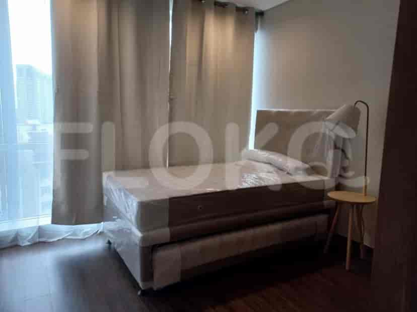 Bedroom featuring a single bed, side table, and curtain.