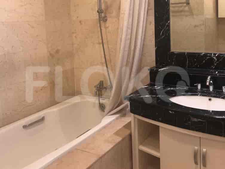 A bathroom with a bathtub, shower, sink, and marble countertops.