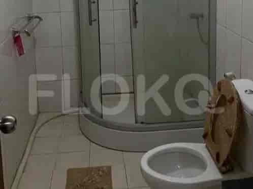 Bathroom with a shower, toilet, and a simple design.