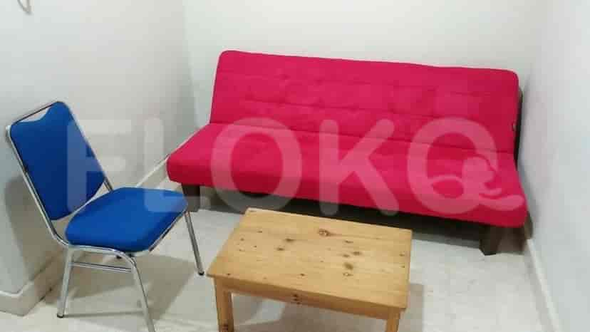 A compact living area with a sofa and a small table.