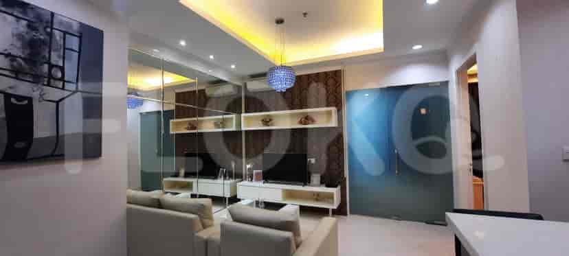 Spacious living room with a modern style, white furniture, and decorative ceiling lights.