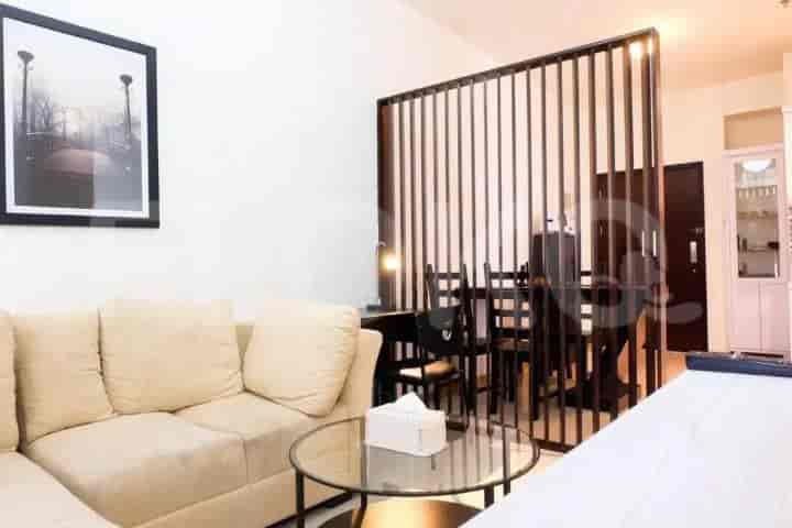 Living and dining area with a room divider, sofa, and dining table.