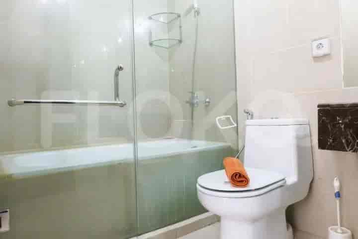 Bathroom with a bathtub, toilet, and shower area.