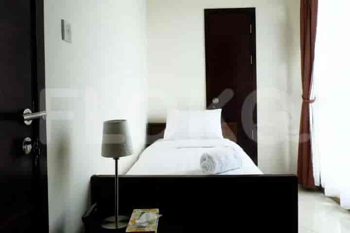 Single bed with white bedding in a bedroom.