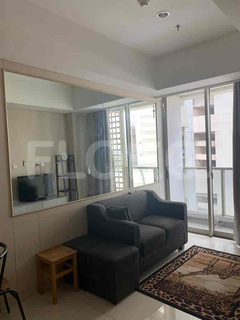 Living room with a grey sofa and large mirror.
