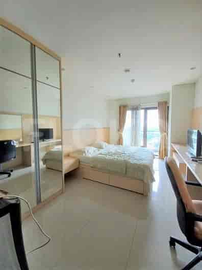 Spacious bedroom with a large bed, mirrored closet, and a desk setup.