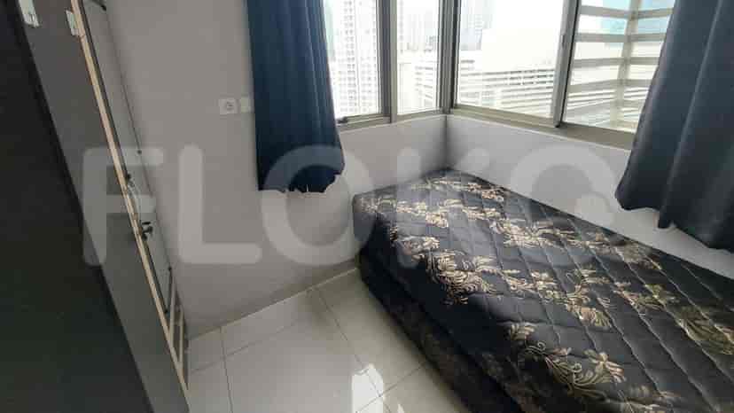 A small bedroom with a single bed and a window.