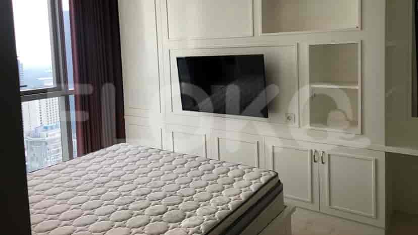 Another view of the bedroom with bed and TV.