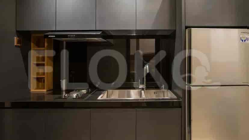 Modern kitchen design with stainless steel appliances and dark grey cabinets.
