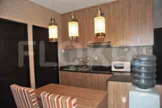 Kitchen with wooden cabinets and a water dispenser.