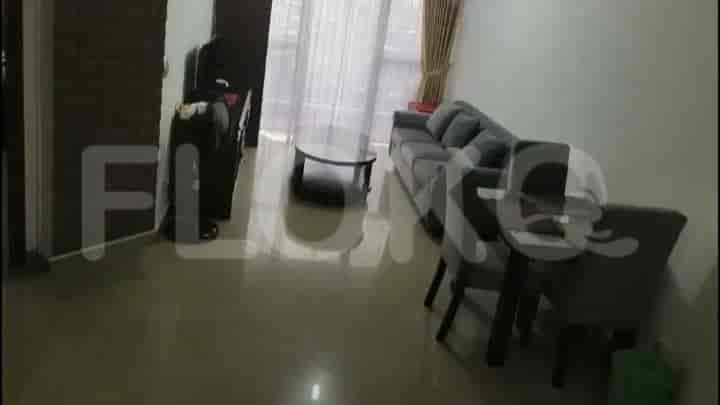 A living room with a grey sofa, a coffee table, and access to other rooms.
