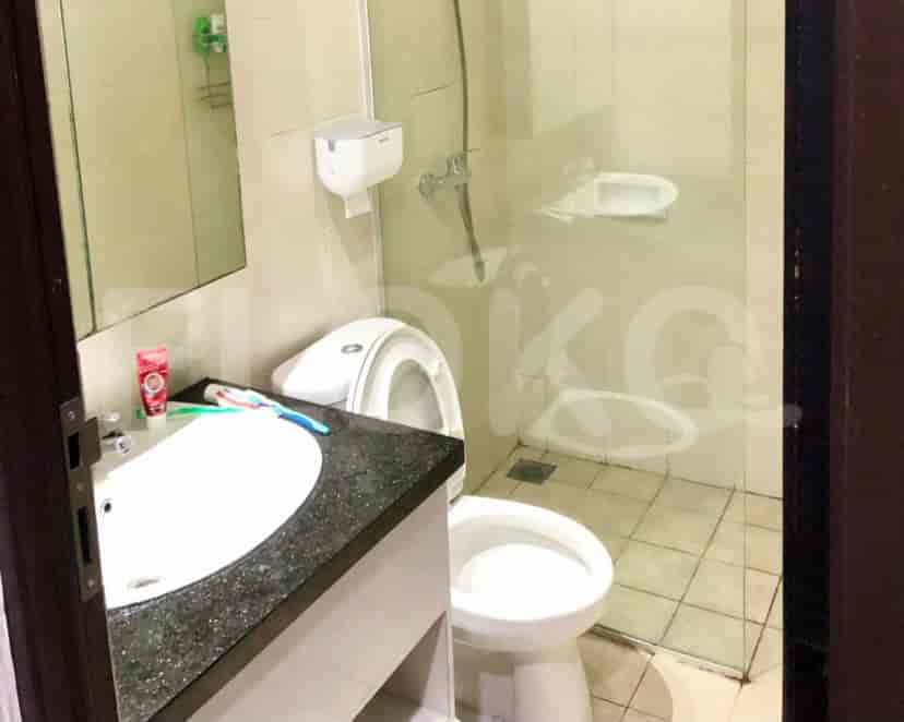A bathroom with a sink, toilet, and a shower area.
