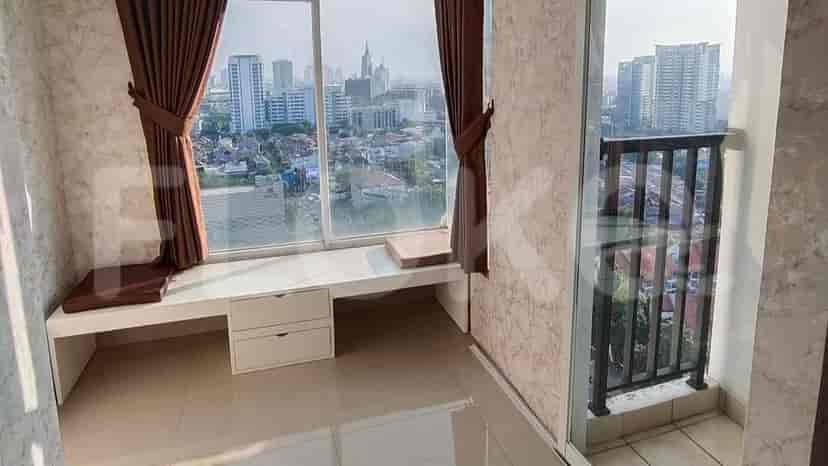A balcony area with a window seat and city view.