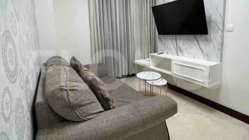 Modern living room featuring a gray sofa, wall-mounted TV, and stylish decor.