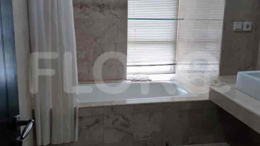 Bathroom with bathtub, sink and window.