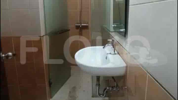 A bathroom with a sink and shower, highlighting the simplicity and functionality of the space.