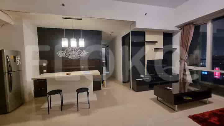 Ruang tamu dan dapur gabungan dengan meja sarapan dan lemari es stainless steel.
