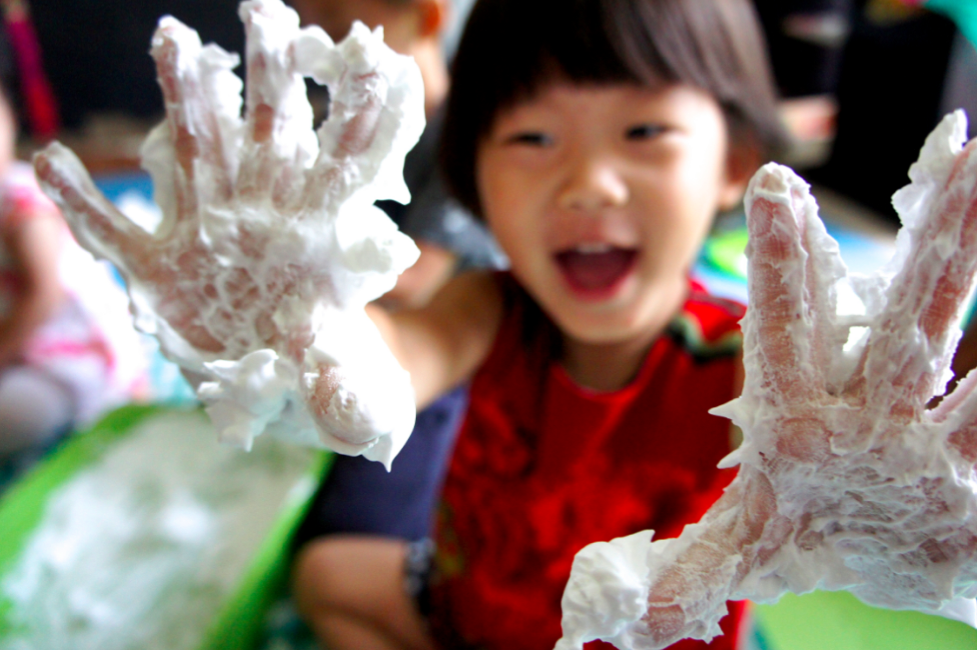 a kid playing with foam