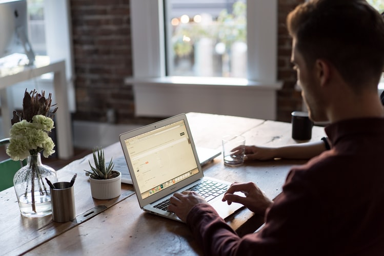 man in front of a laptop