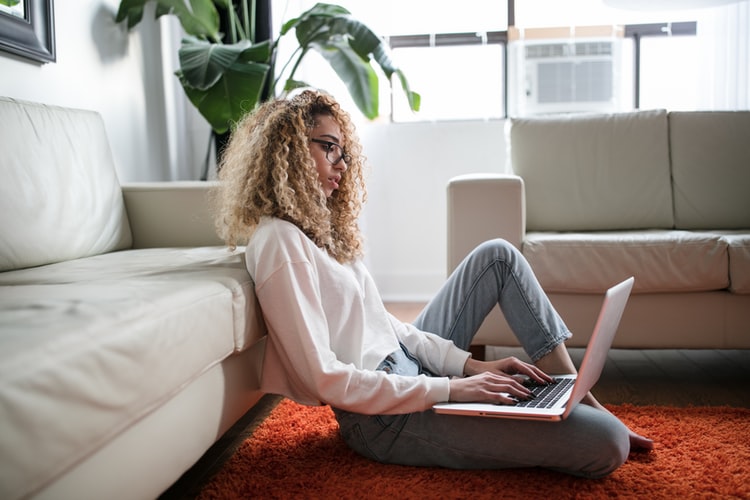 women in front of laptop sitting