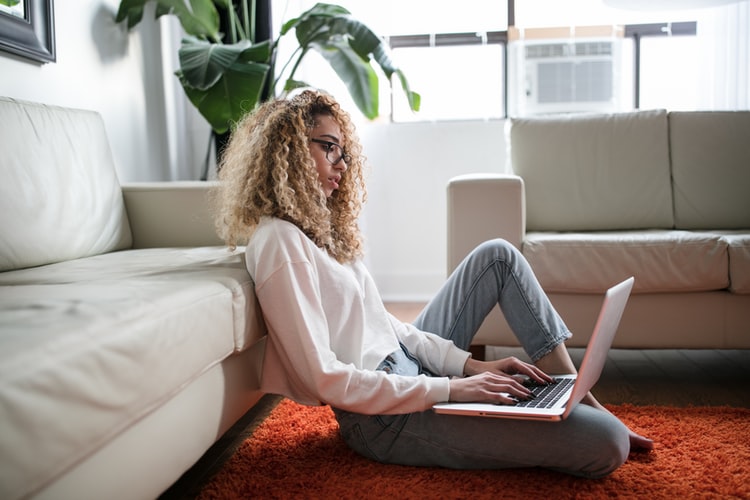 women in front of laptop sitting 